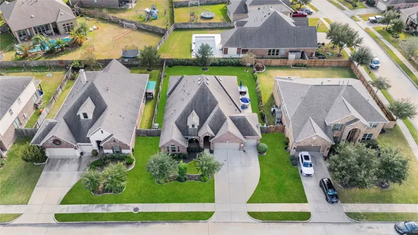 an aerial view of a house with a garden and a yard