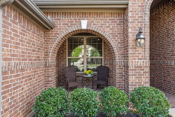 a front view of a house with plants