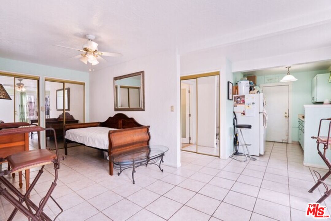 3945 Las Flores Canyon Road Malibu, CA 90265 - Photo 13 of 45 a bedroom with a bed and a chandelier