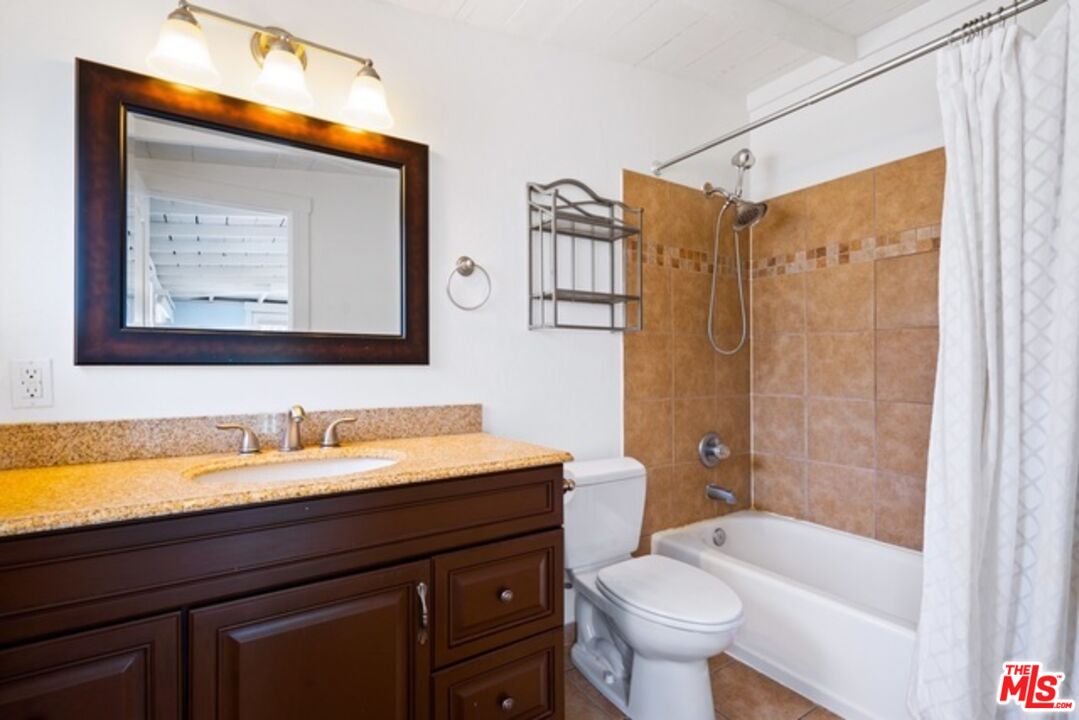 3945 Las Flores Canyon Road Malibu, CA 90265 - Photo 16 of 45 a bathroom with a double vanity sink toilet and shower