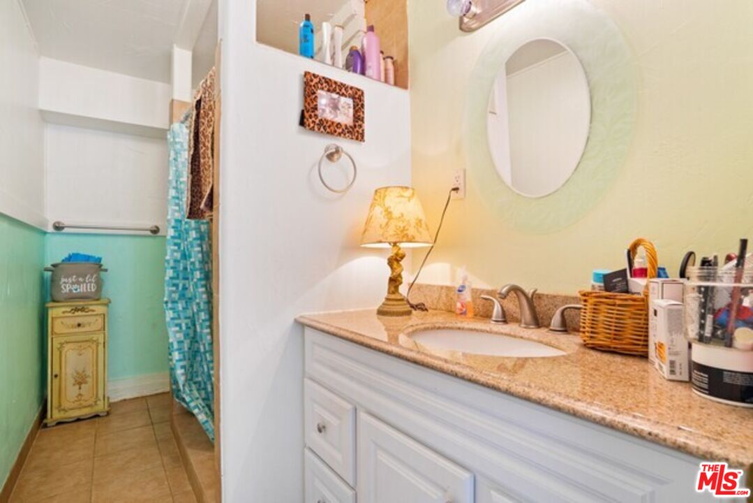3945 Las Flores Canyon Road Malibu, CA 90265 - Photo 18 of 45 a bathroom with a granite countertop sink and a mirror