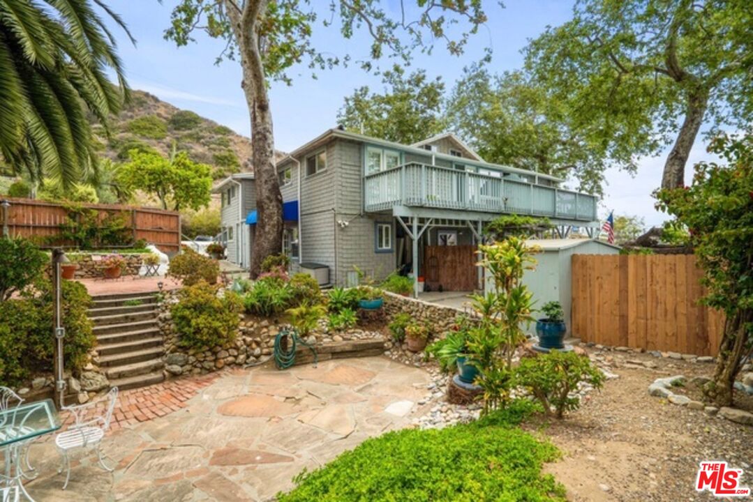 3945 Las Flores Canyon Road Malibu, CA 90265 - Photo 19 of 45 a front view of a house with a yard