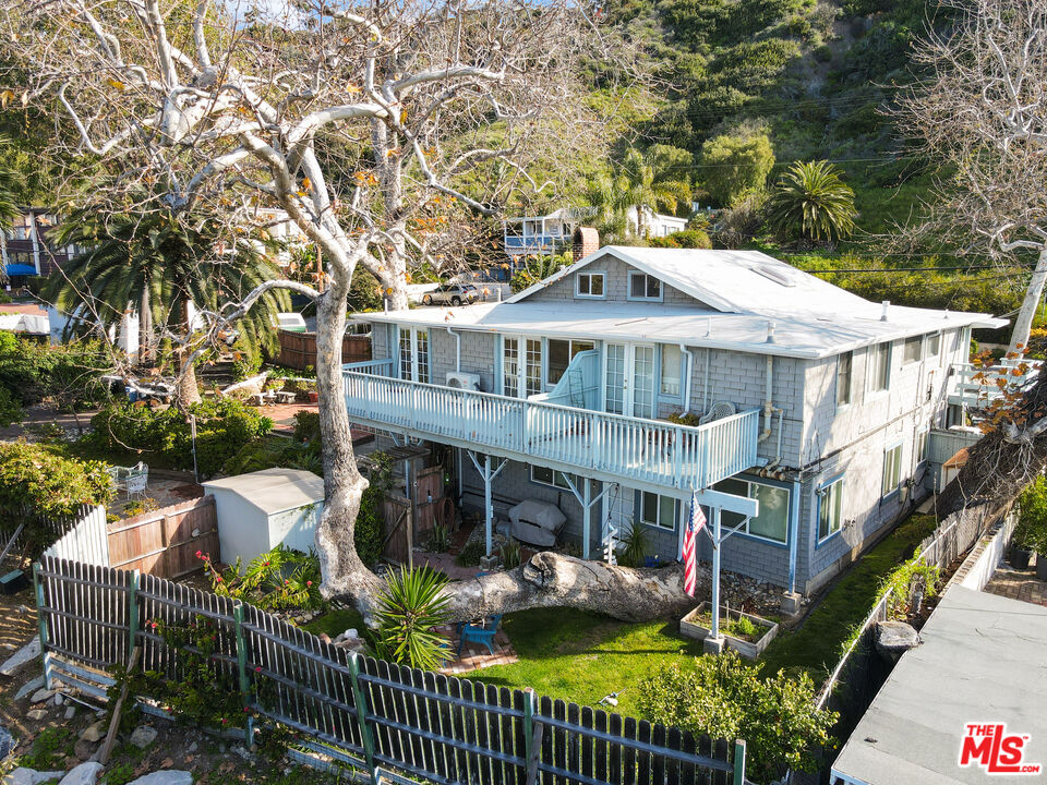 3945 Las Flores Canyon Road Malibu, CA 90265 - Photo 21 of 45 a balcony with table and chairs