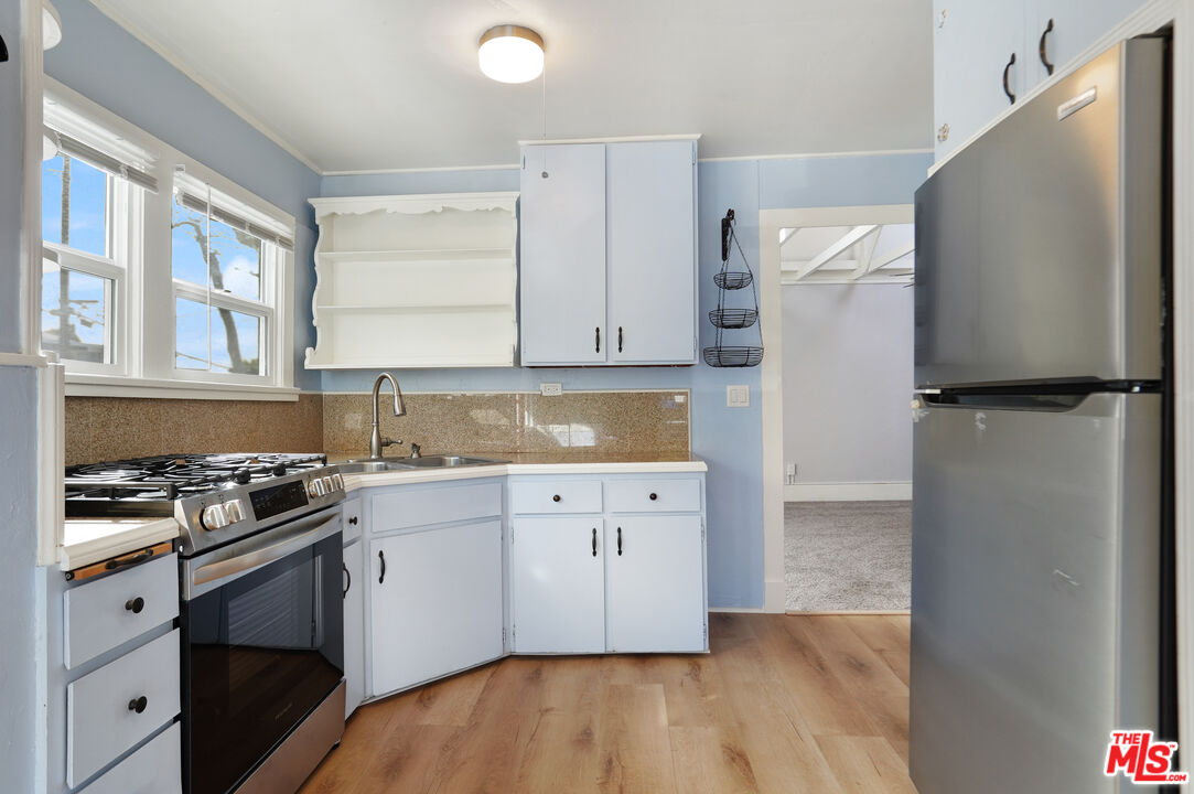 3945 Las Flores Canyon Road Malibu, CA 90265 - Photo 26 of 45 a kitchen with a refrigerator and a stove