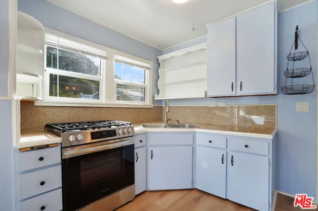 a kitchen with granite countertop white cabinets and white appliances