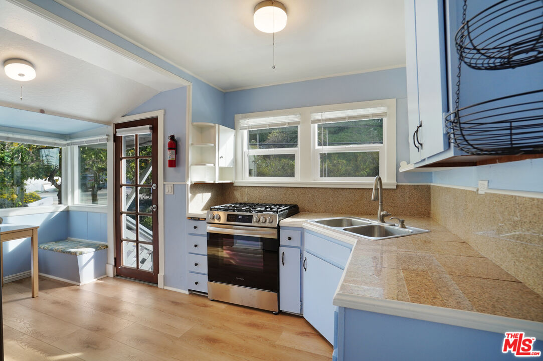 3945 Las Flores Canyon Road Malibu, CA 90265 - Photo 29 of 45 a kitchen with stainless steel appliances granite countertop a stove and a sink