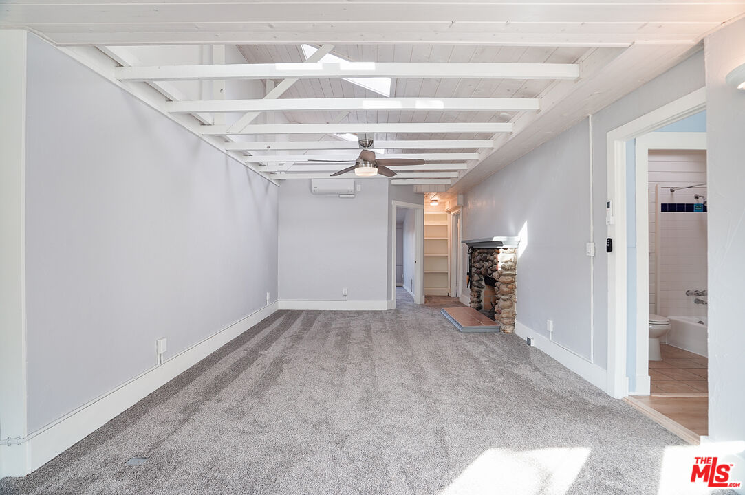 3945 Las Flores Canyon Road Malibu, CA 90265 - Photo 32 of 45 a view of hallway with stairs and a chandelier