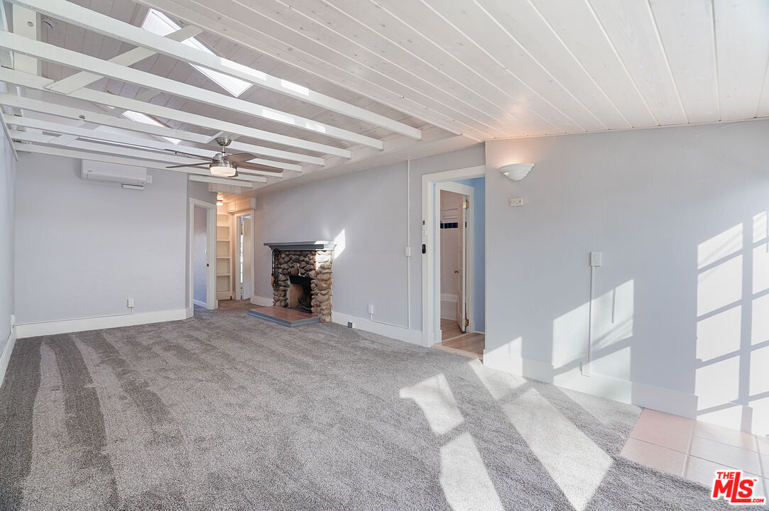 3945 Las Flores Canyon Road Malibu, CA 90265 - Photo 35 of 45 a view of empty room with furniture and fireplace