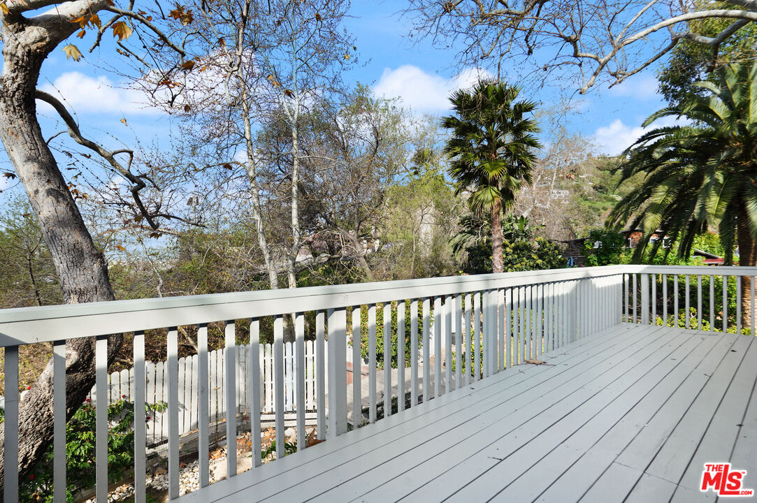 3945 Las Flores Canyon Road Malibu, CA 90265 - Photo 39 of 45 a balcony with wooden floor and fence