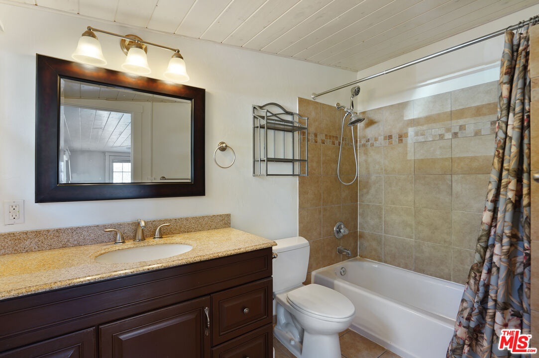3945 Las Flores Canyon Road Malibu, CA 90265 - Photo 41 of 45 a bathroom with a sink a toilet a mirror a bathtub and shower