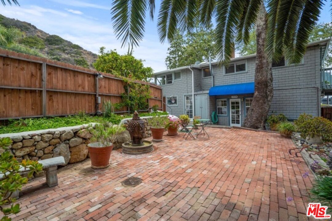3945 Las Flores Canyon Road Malibu, CA 90265 - Photo 5 of 45 a view of a chair and tables in the backyard