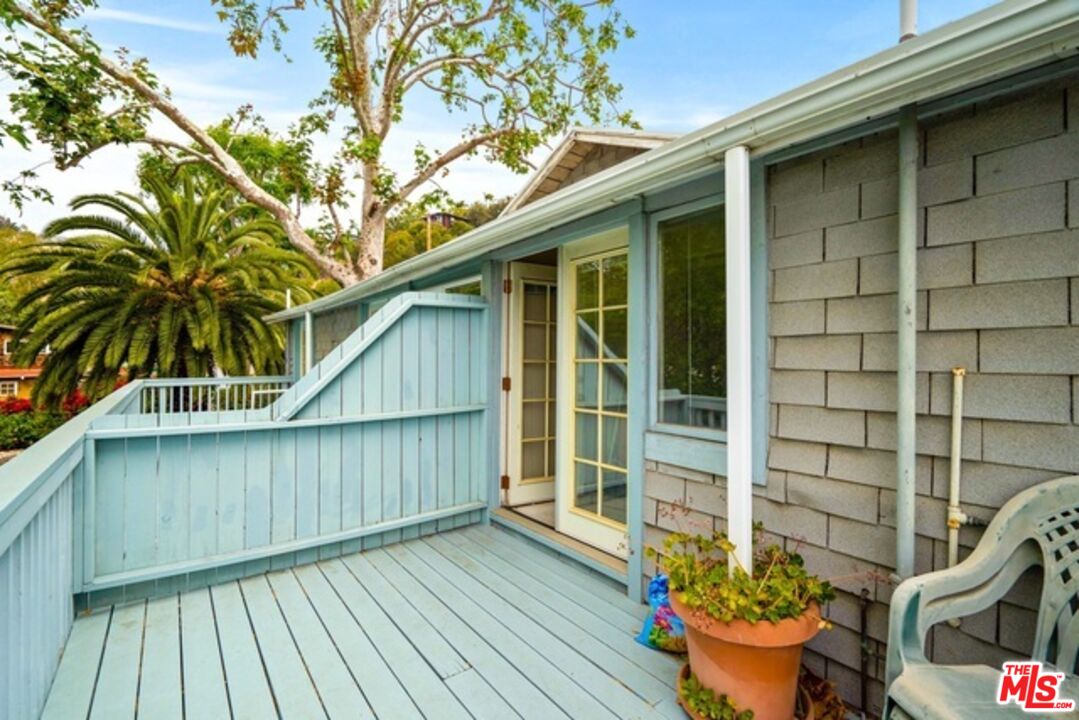 3945 Las Flores Canyon Road Malibu, CA 90265 - Photo 7 of 45 a view of wooden house with a potted plant and a large window