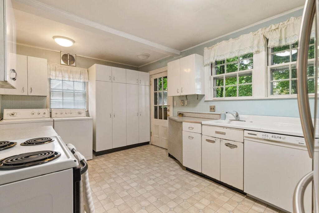 5 Hosmer Circle Newton, MA 02465 - Photo 18 of 32 a kitchen with granite countertop white cabinets and white appliances