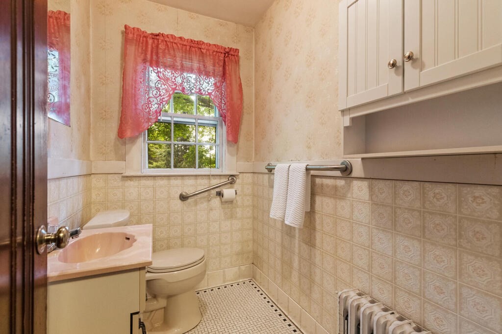 5 Hosmer Circle Newton, MA 02465 - Photo 24 of 32 a bathroom with a toilet a sink and a shower curtain