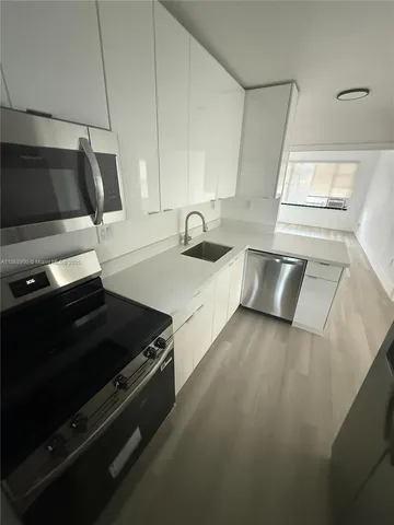 a kitchen with granite countertop a stove and a sink