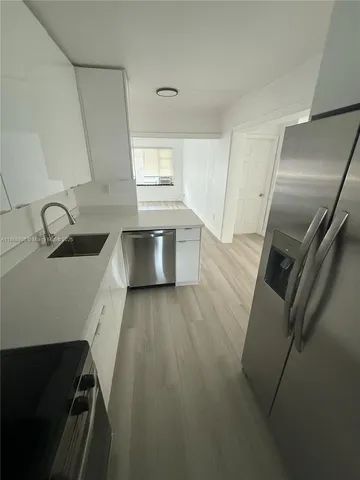 a kitchen with a sink and refrigerator