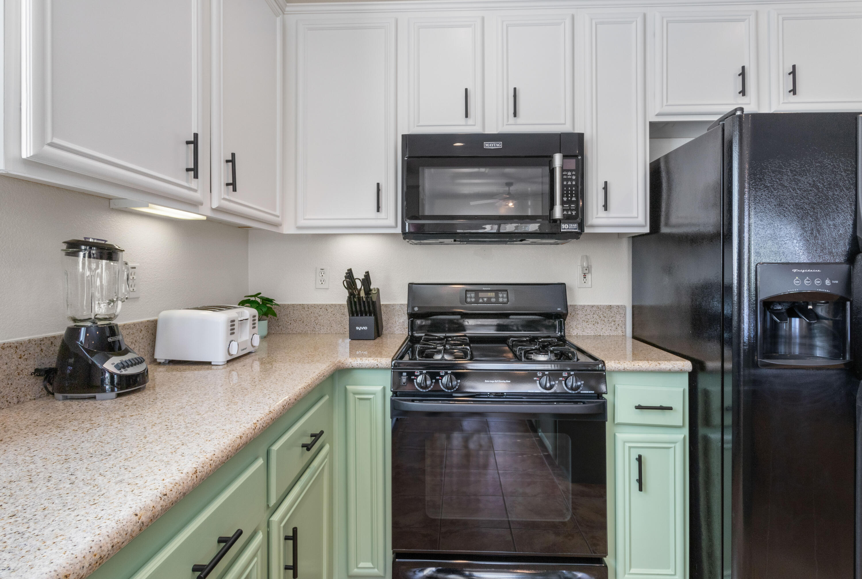 82664 Heston Drive Indio, CA 92201 - Photo 22 of 75 a kitchen with stainless steel appliances granite countertop a stove a microwave and cabinets