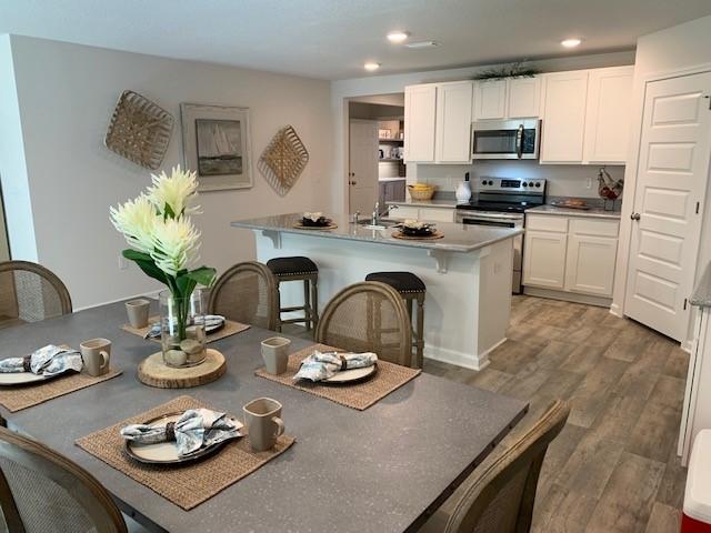 4659 Honor Guard Way Crestview, FL 32539 - Photo 4 of 25 a open kitchen with sink a refrigerator and microwave