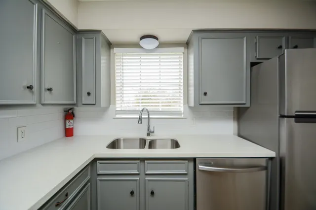 a kitchen with a sink cabinets and window