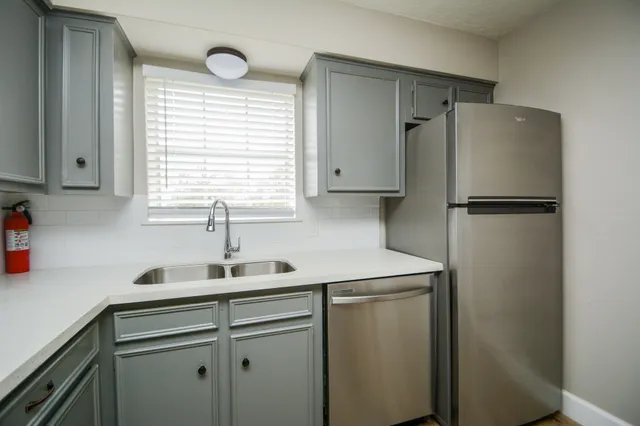 a white refrigerator freezer sitting inside of a kitchen