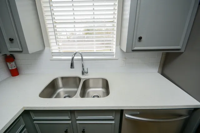 a kitchen with a sink and cabinets