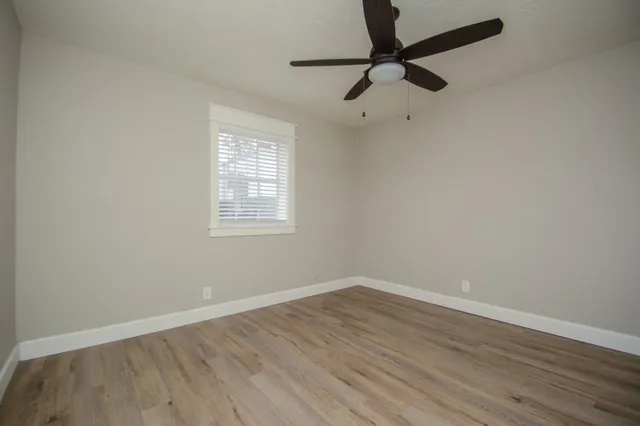 wooden floor in an empty room with a window