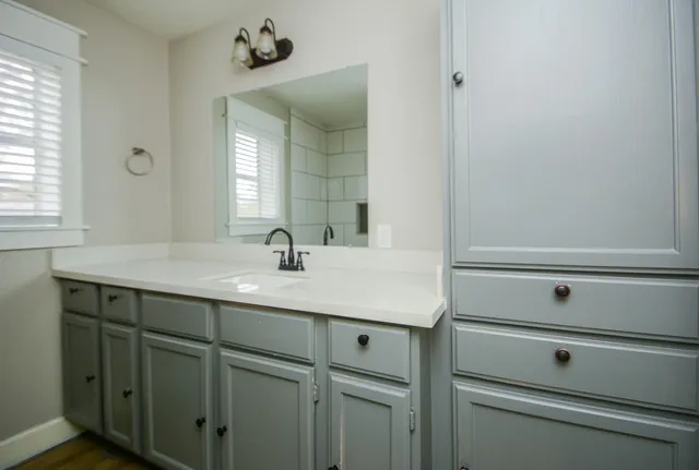a bathroom with a sink and a mirror