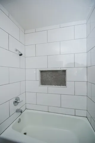 a bathroom with a bathtub and shower