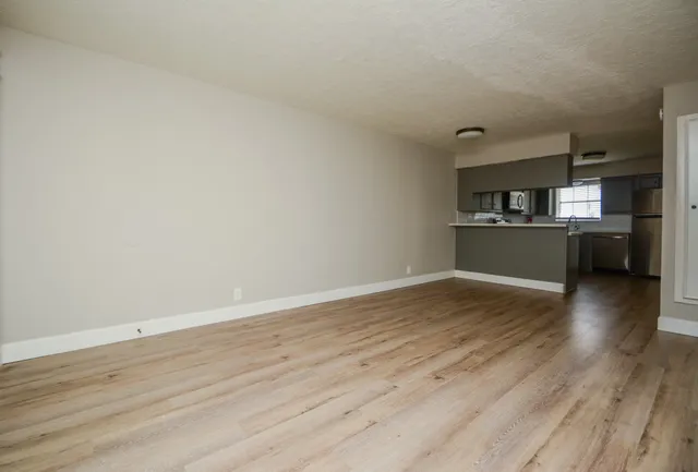 a view of a kitchen with wooden floor and a kitchen