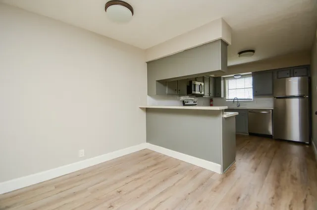 a kitchen with a refrigerator sink and cabinets
