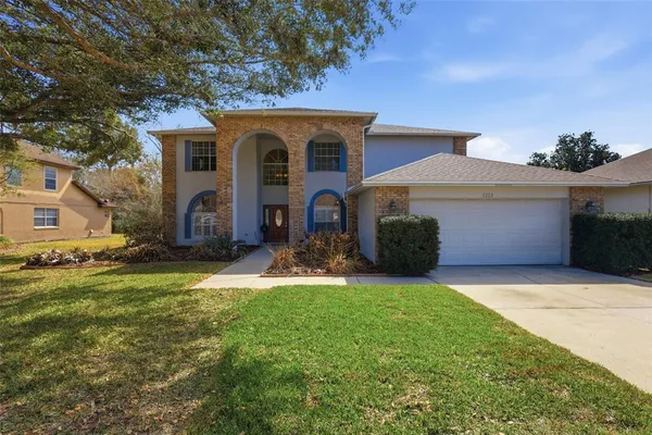 a front view of a house with a yard and garage