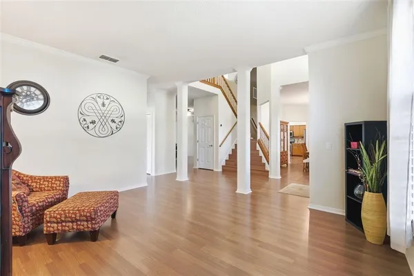a living room with furniture and a wooden floor