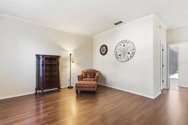 a living room with wooden floor and a window