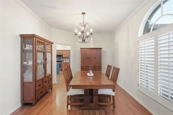 a view of a dining room with furniture window and wooden floor