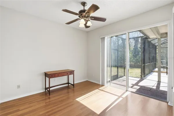 a work room with wooden floor and a ceiling fan