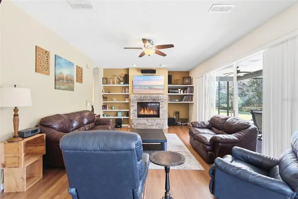 a living room with furniture ceiling fan and a window
