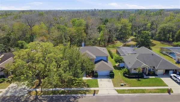 an aerial view of house with yard swimming pool and mountains