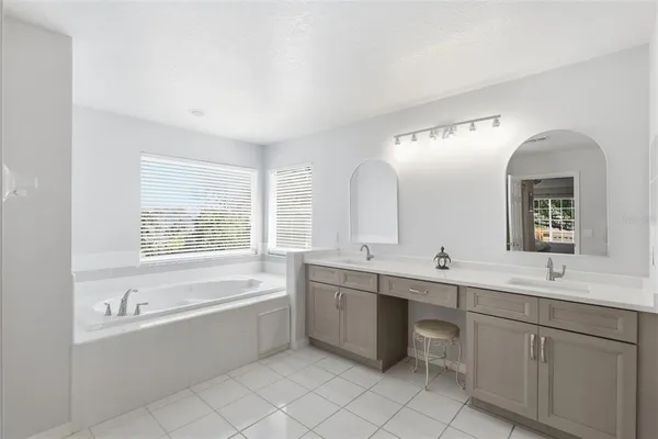 a bathroom with a bathtub a sink and a window