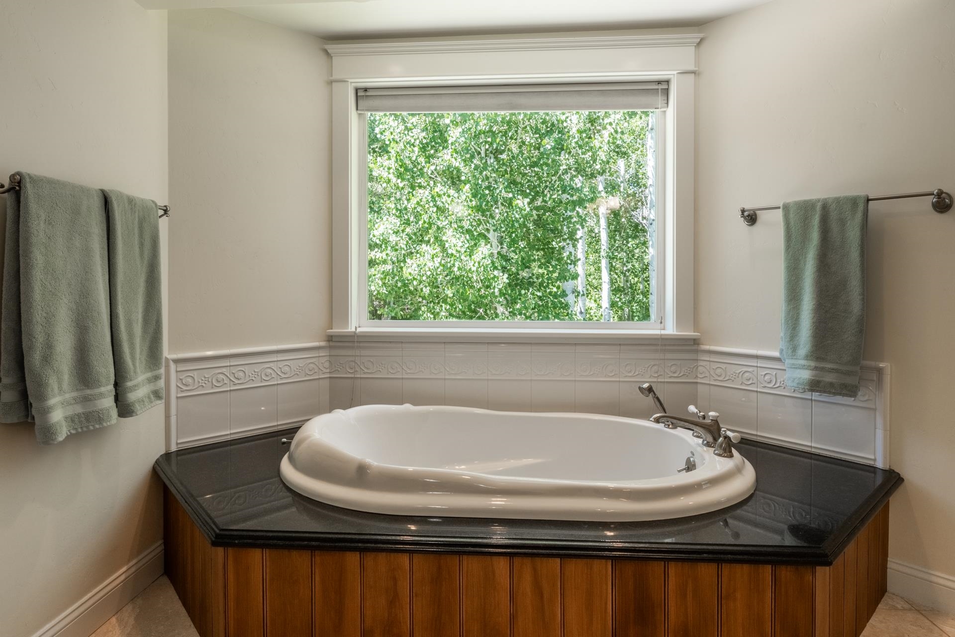 22 Juniper Drive, Unit 2 Mammoth Lakes, CA 93546 - Photo 22 of 50 a bathroom with a granite countertop sink and a bathtub