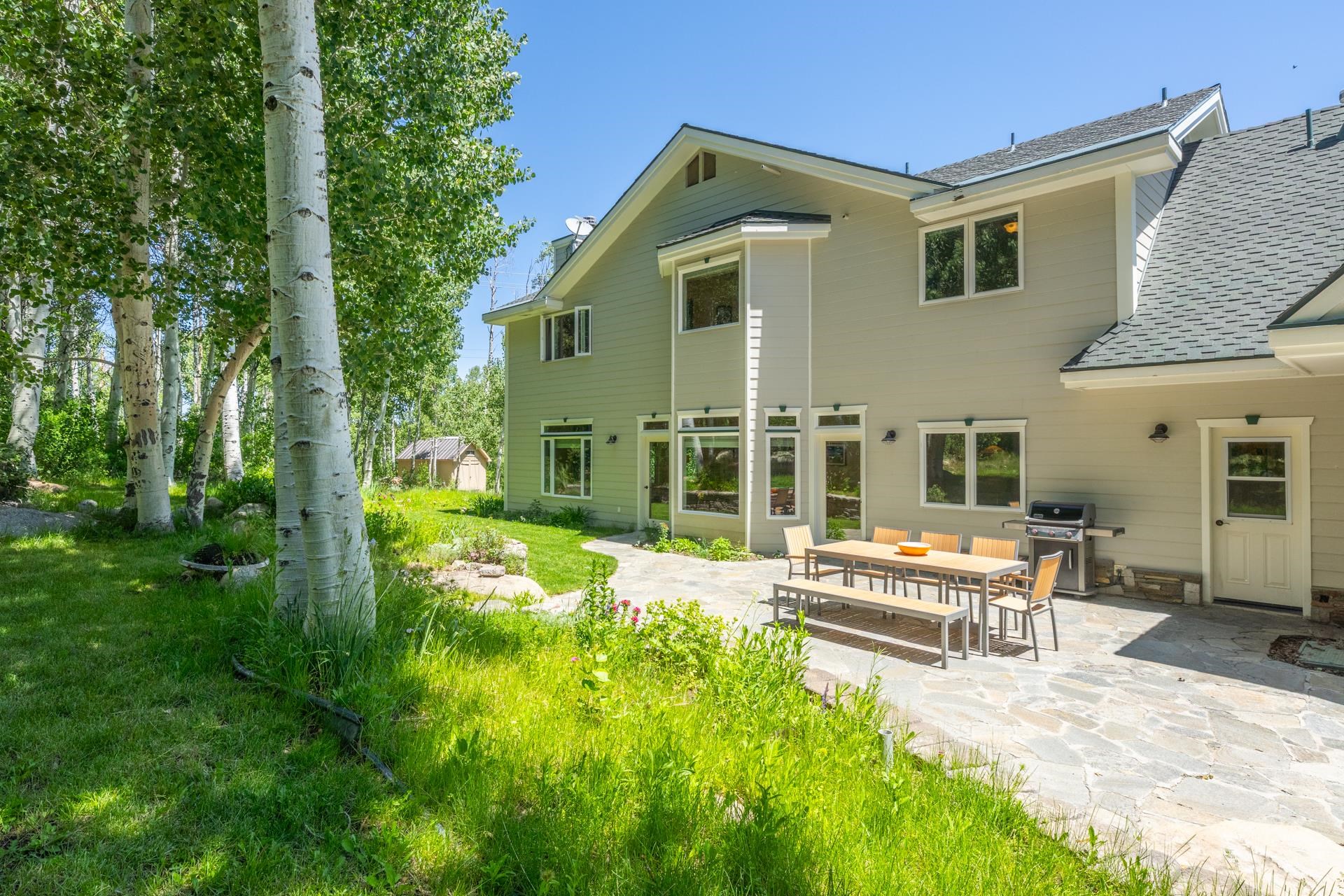 22 Juniper Drive, Unit 2 Mammoth Lakes, CA 93546 - Photo 30 of 50 a front view of a house with a yard table and chairs