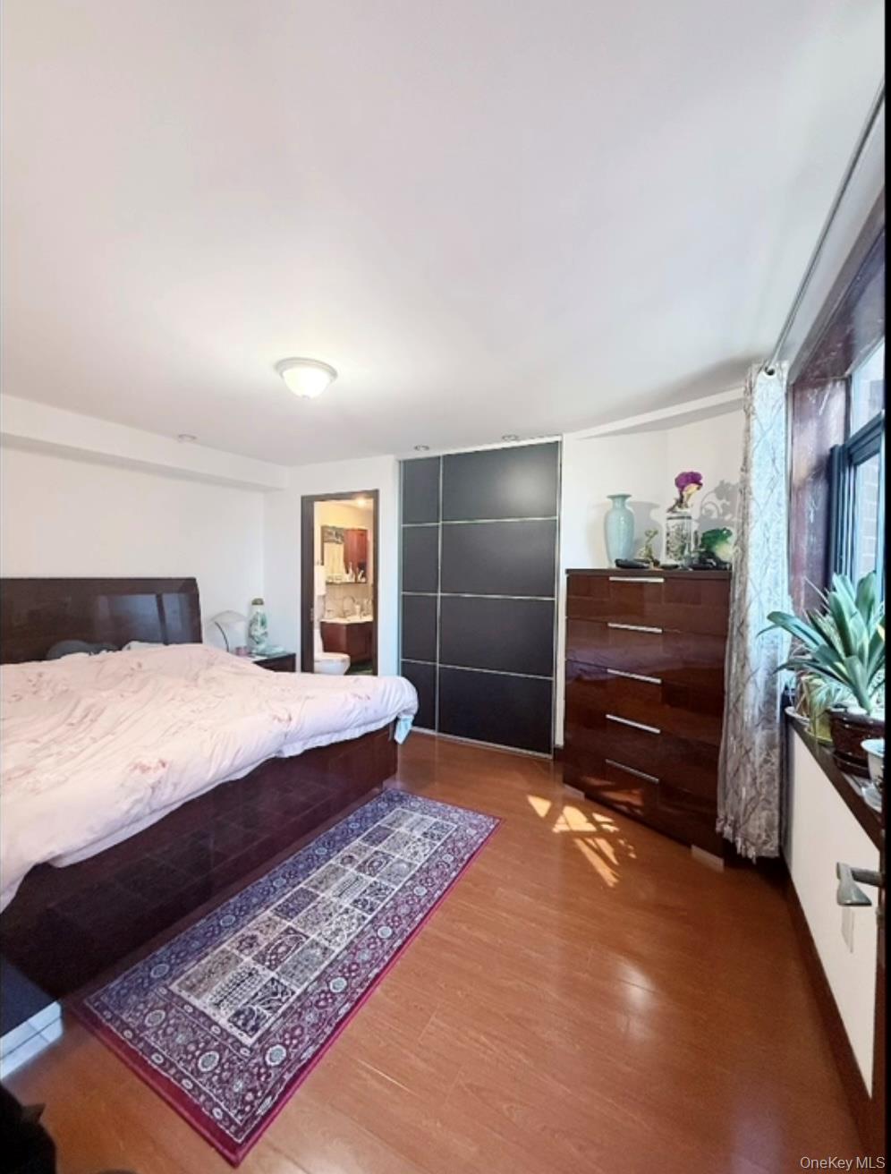 132-29 Blossom Avenue, Unit 6 Queens, NY 11355 - Photo 2 of 9 a bed room with a bed and a television