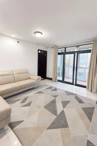 a view of a livingroom with a couch and large windows