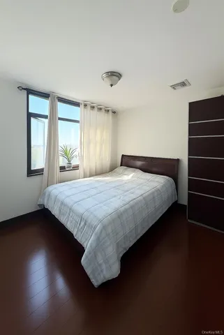 a bedroom with a bed and window