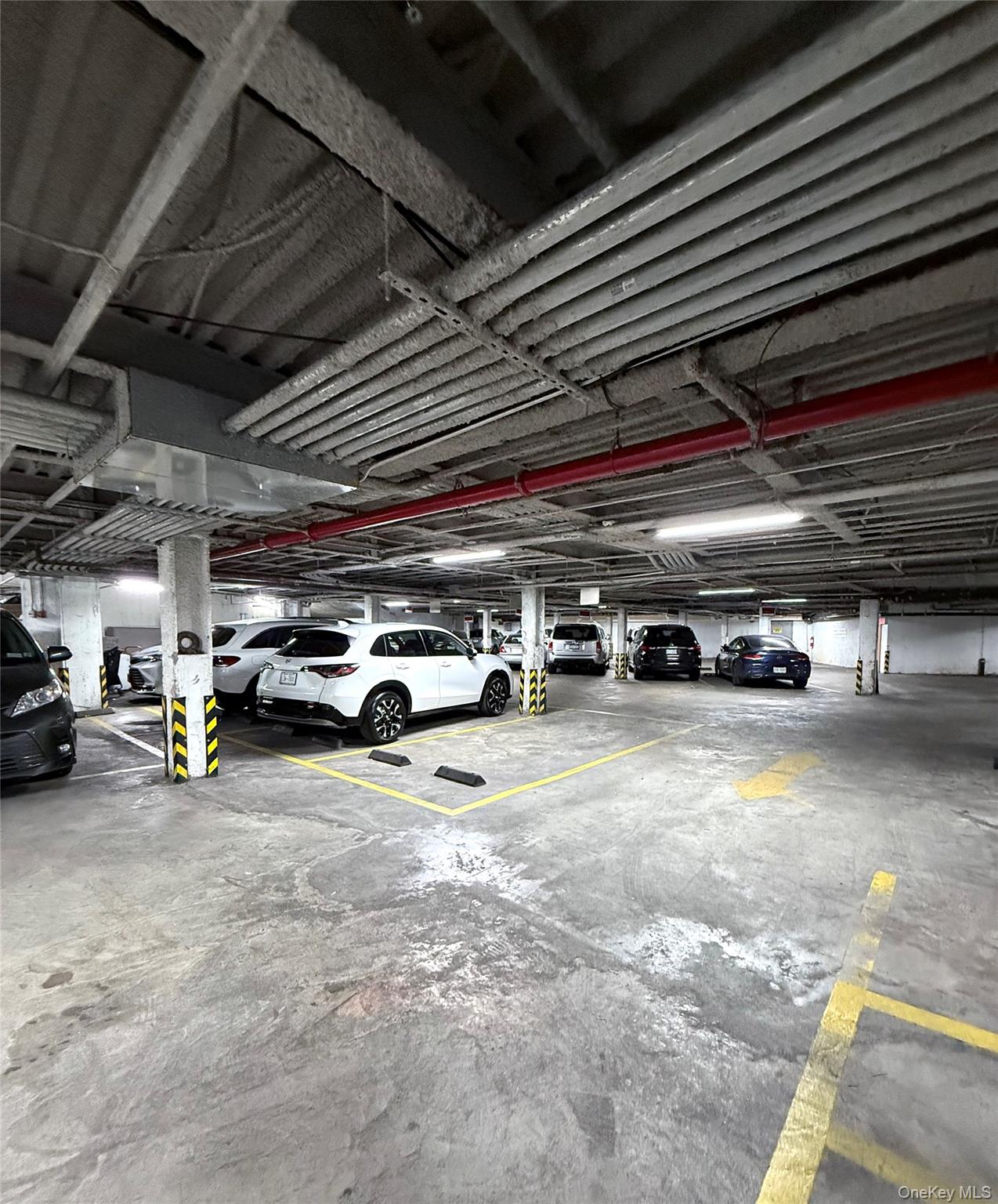 132-29 Blossom Avenue, Unit 6 Queens, NY 11355 - Photo 6 of 9 a view of parking garage with cars