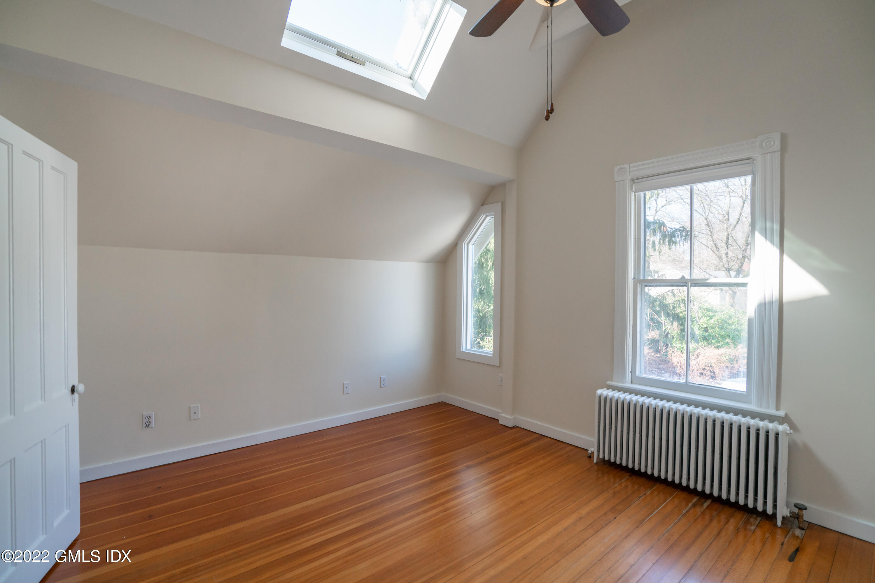 48 Sinawoy Road Cos Cob, CT 06807 - Photo 18 of 25 a view of empty room with wooden floor and fan