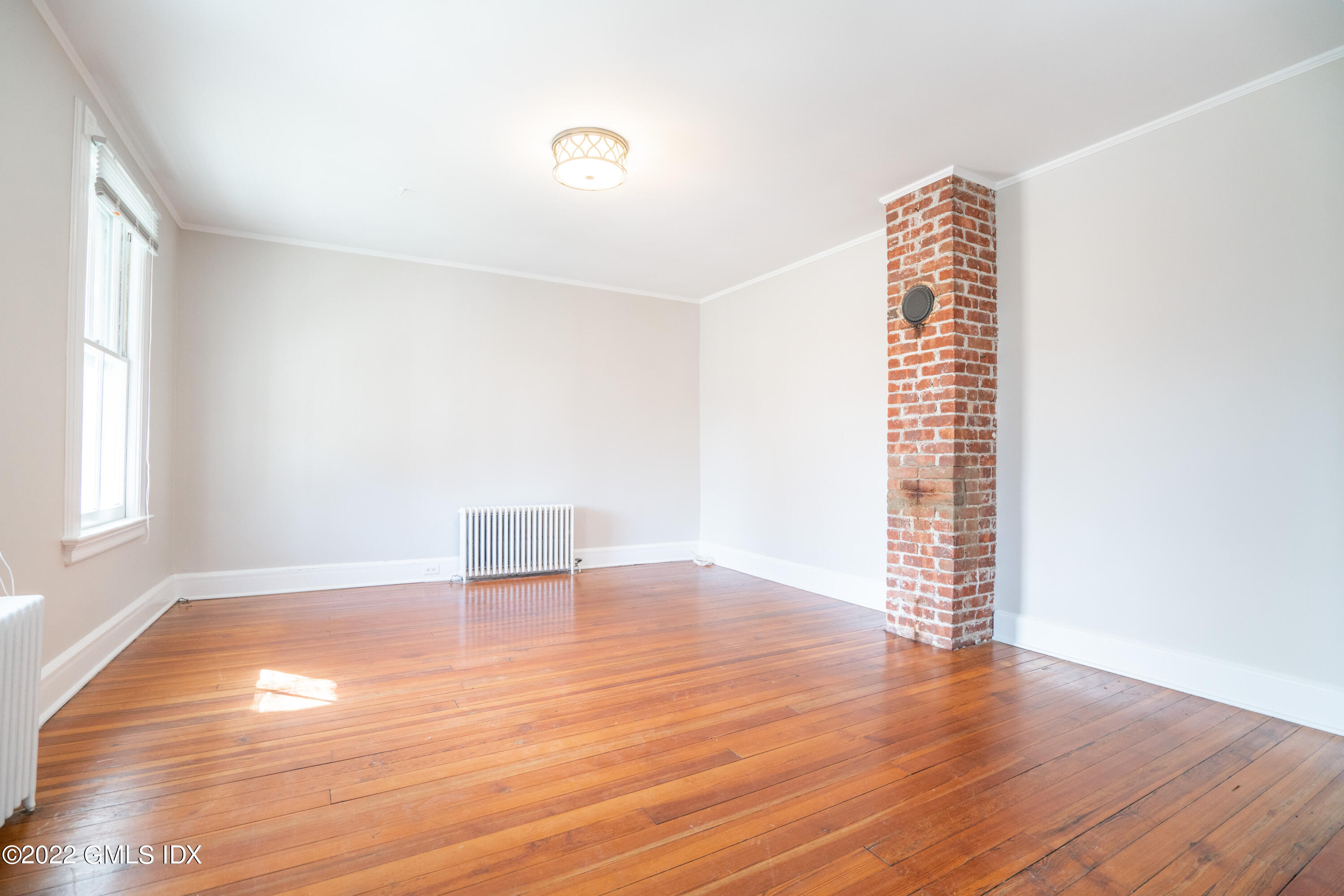 48 Sinawoy Road Cos Cob, CT 06807 - Photo 5 of 25 an empty room with wooden floor and windows