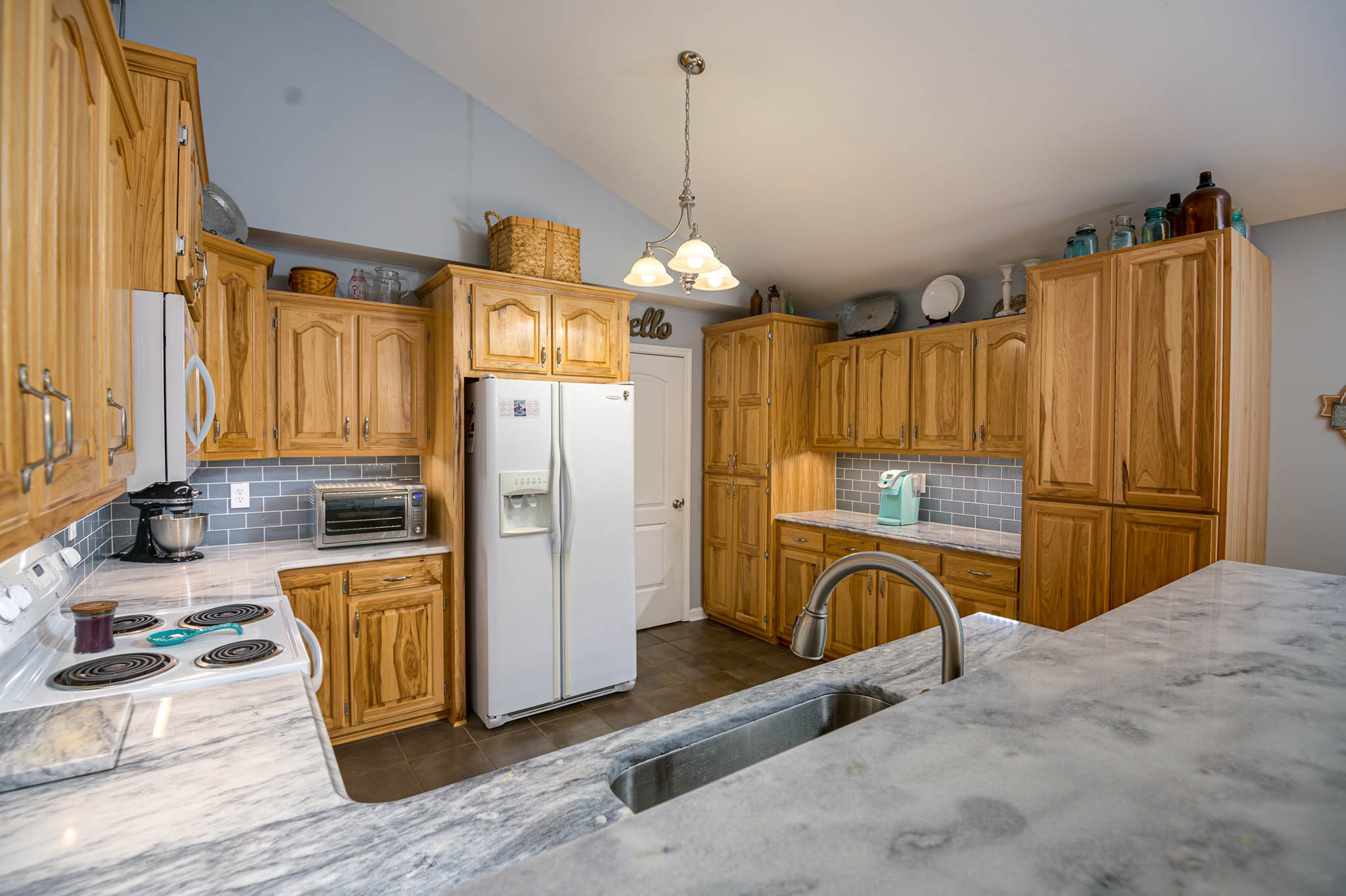 2245 Lower Helton Road Alexandria, TN 37012 - Photo 8 of 43 a kitchen with refrigerator a stove a sink and a window
