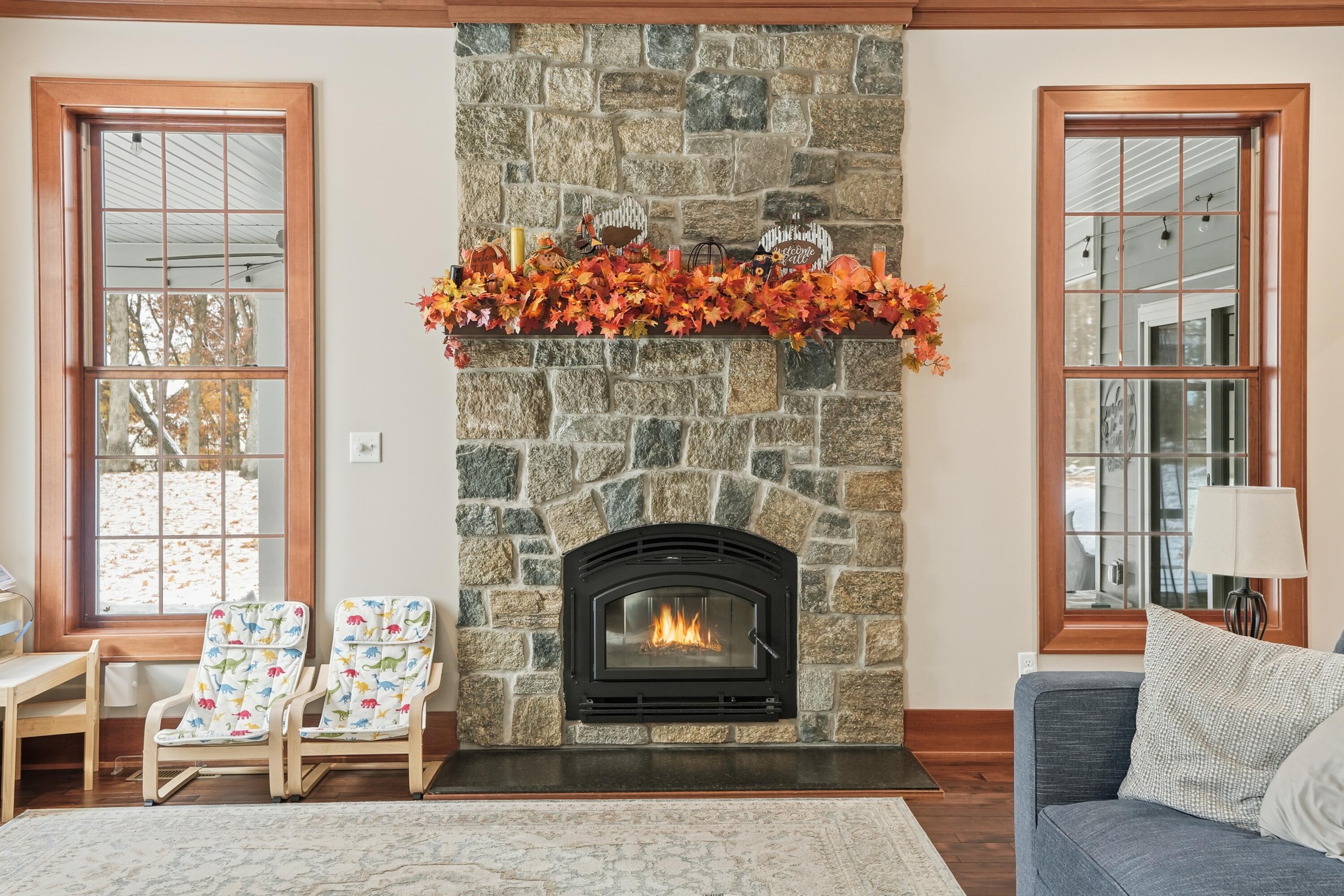 804 Shannon Drive Crown Point, IN 46307 - Photo 26 of 79 a living room with a fireplace a dining table and a fireplace
