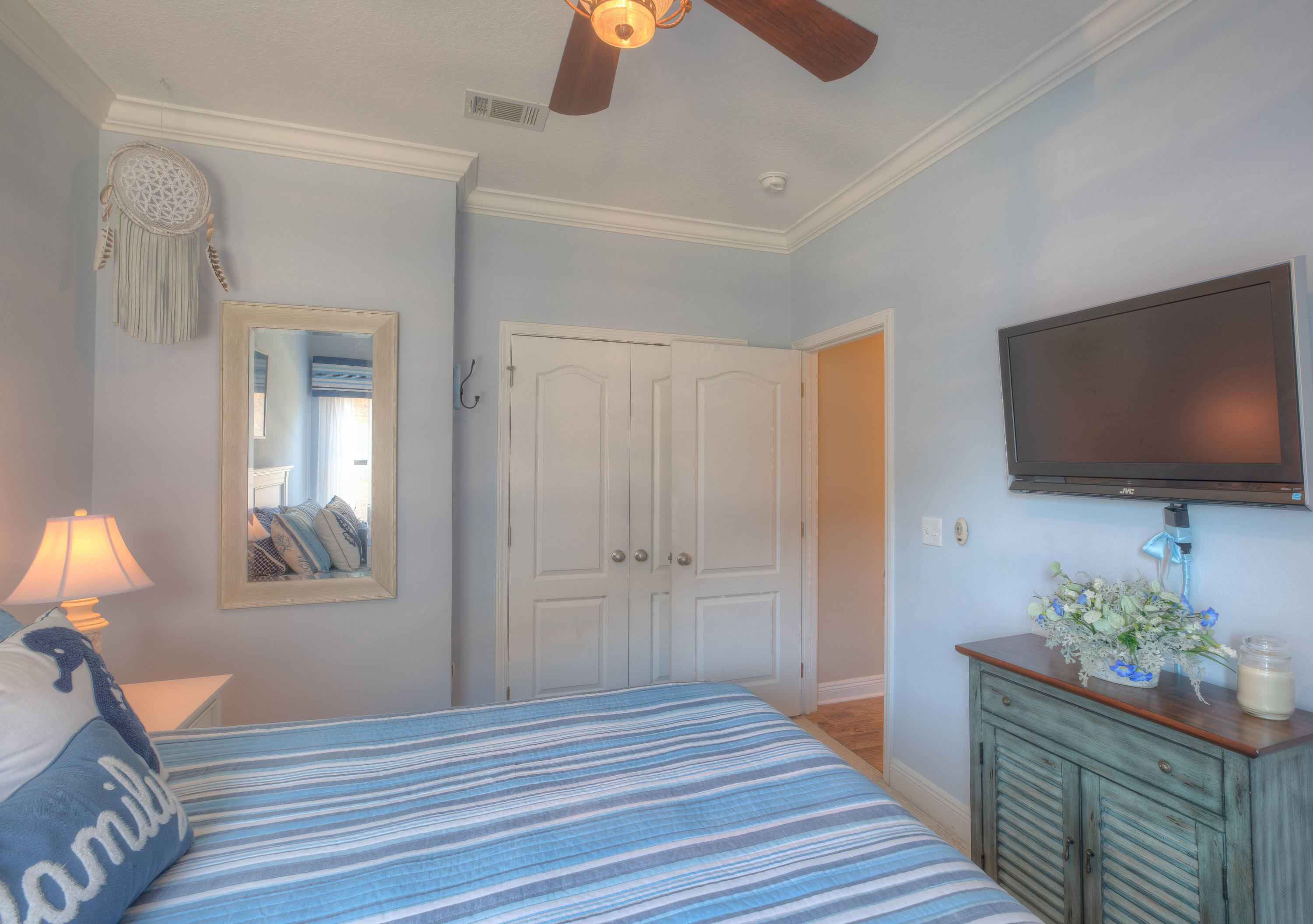 456 Pin Oak Loop Santa Rosa Beach, FL 32459 - Photo 16 of 32 a bedroom with wooden floor and a flat screen tv