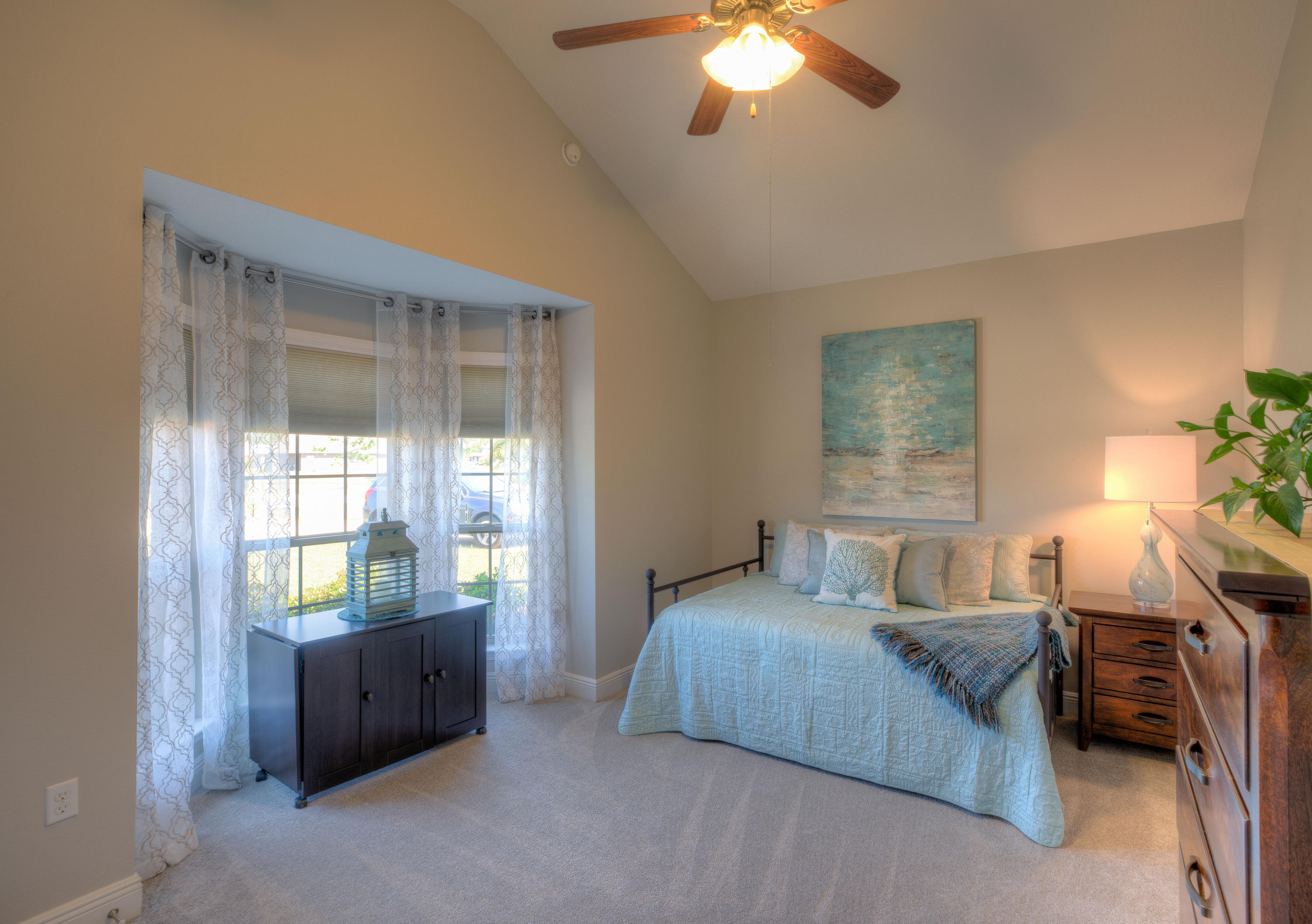 456 Pin Oak Loop Santa Rosa Beach, FL 32459 - Photo 17 of 32 a bedroom with a bed and a chandelier